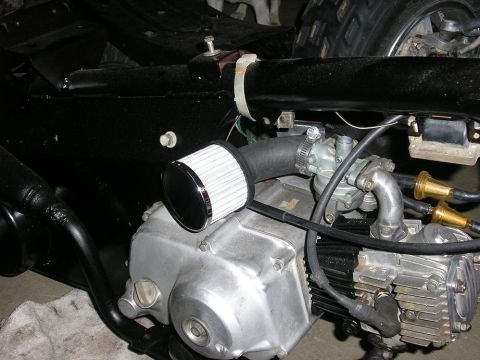 1900 Honda Big Red - The engine features a custom air intake system and appears to be undergoing maintenance or modification.