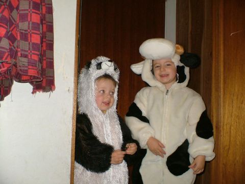 1989 Ford Bronco - Two children dressed in panda and cow costumes stand indoors.