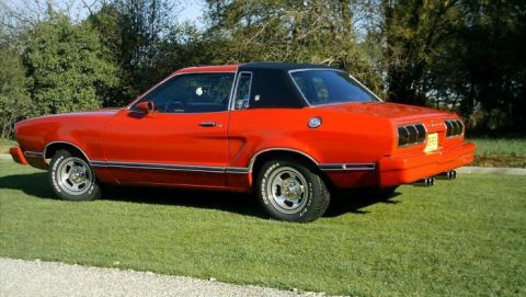1978 Ford Mustang II - Rear three-quarter view of a red 1978 Ford Mustang II coupe with a black vinyl roof.