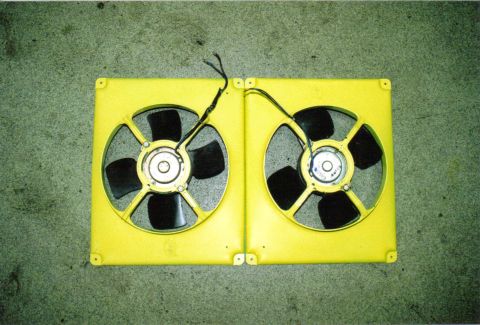 1986 Ford Bronco - A pair of yellow electric fans are shown, likely for automotive use.
