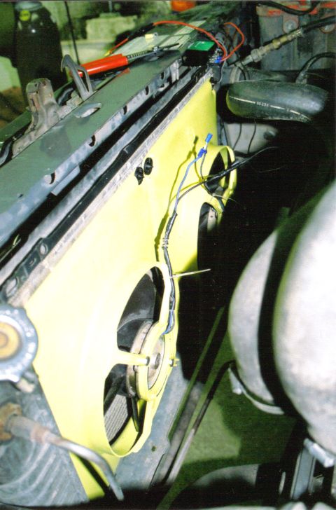 1986 Ford Bronco - Close-up view of an aftermarket electric fan installation in a vehicle's engine bay.