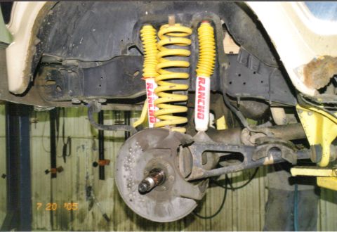 1986 Ford Bronco - Close-up of the front suspension system yellow Rancho shocks and springs, with a date stamp of July 20, 2005.