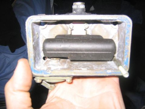 1969 Ford Mustang - A close-up view of a carburetor float bowl, showing the internal float mechanism.