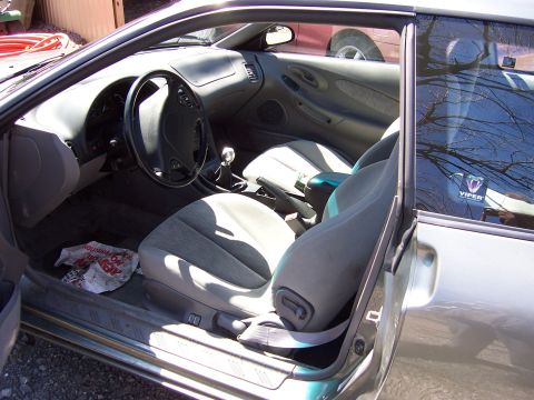 1996 Ford Probe - The interior of a car is shown, with a Viper sticker visible on the rear passenger window.