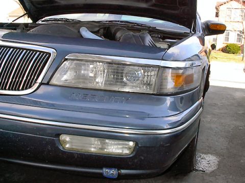 1985 Mercury Grand Marquis - The 'MERCURY' badge is visible on the front of the car, and the headlights and grille are intact.