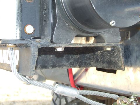 1986 Ford Bronco - Close-up of a winch mounting bracket, showing the Rancho logo and steel cable attachment.