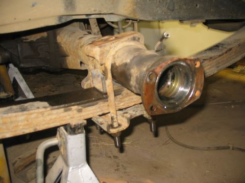 1981 Ford Bronco - Close-up of a rusty rear axle assembly supported by jack stands, indicating repair or modification.
