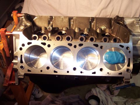 1981 Ford Bronco - This is an engine block with pistons visible, with blue putty placed in one of the cylinders.