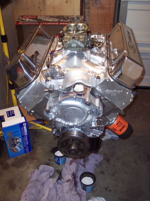 1981 Ford Bronco - A polished V8 engine sits on a garage floor, ready for installation.