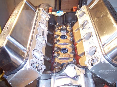1981 Ford Bronco - Close-up of an engine block with timing chain and polished valve covers.