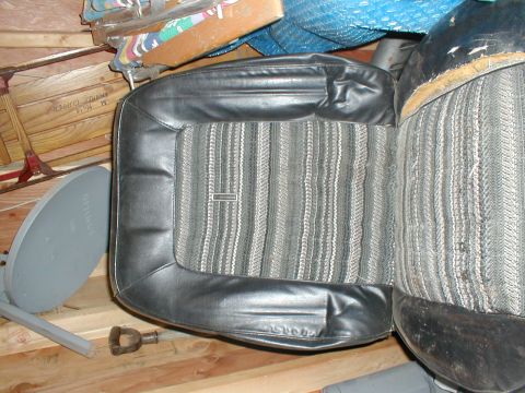 1979 Ford Bronco - A close-up view of a vintage car seat with a distinctive striped fabric pattern.