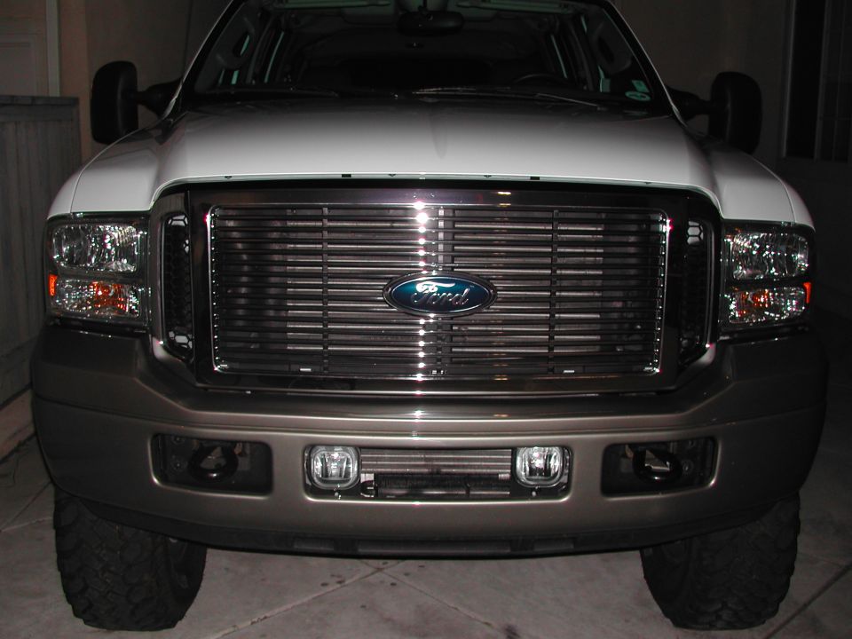 Front view of a 2005 Ford Excursion with a chrome grille and Ford logo