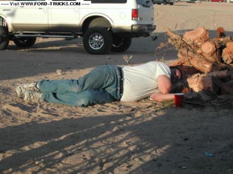 2005 Ford Excursion - Buddy passed out on wood pile New Years @ Superstition.. Ex in Background.