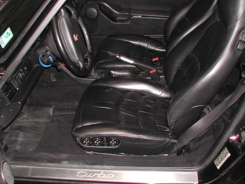 Black leather Porsche 911 interior with turbo-scripted door sill plate
