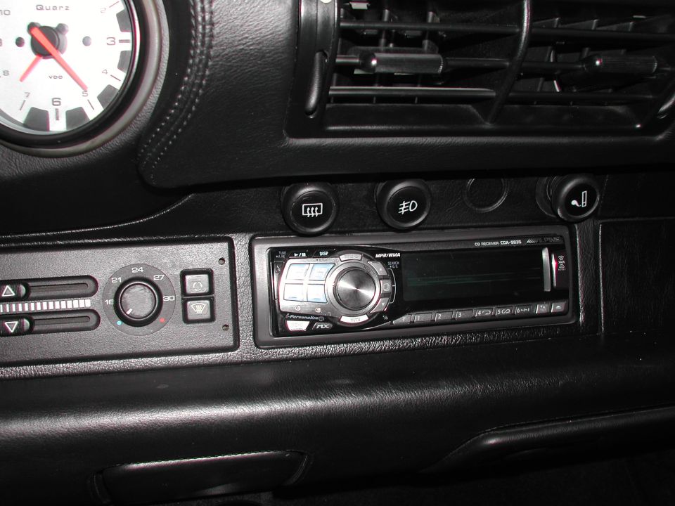 Black leather dash with VDO clock, HVAC sliders and an Alpine CDA-9835 CD receiver