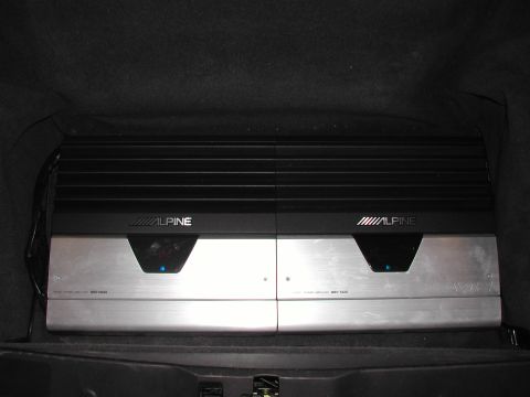 1997 Porsche 911 - Two Alpine MRV-T750 amplifiers are mounted side-by-side in the cargo area of a vehicle.