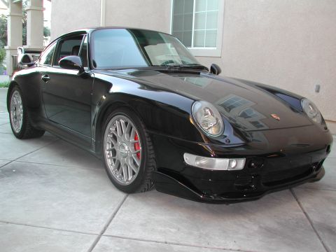 1997 Porsche 911 - Front 3/4 view of a black 1997 Porsche 911.