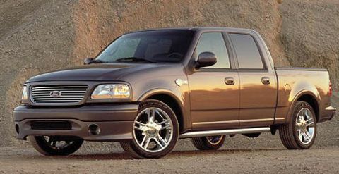 1999 Ford Crown Victoria - This 2001 Ford F-150 SVT Lightning pickup truck is shown in a three-quarter front view on a dirt road.