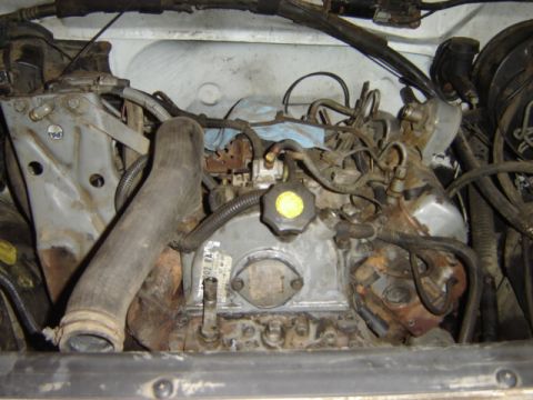 1992 Ford Bronco - Close-up view of an engine compartment, showing various mechanical parts and wiring.