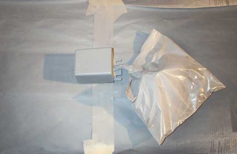 1998 Ford Crown Victoria - A silver A-pillar gauge pod is taped and covered with a plastic bag, likely for protection during a painting or detailing process.