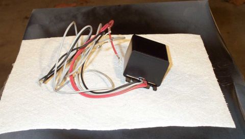 1998 Ford Crown Victoria - A black automotive relay with multiple wires is shown on a white surface.