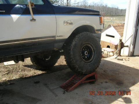 1991 Ford F-150 - A 1991 Ford F-150 is shown with its front tire on a ramp, indicating it might be undergoing maintenance or modification.