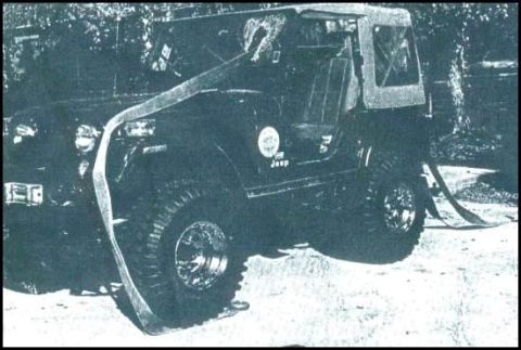 1977 Ford F-150 - A black Jeep CJ-7, adorned with a large ribbon, is parked outdoors with its soft top up and large off-road tires visible.