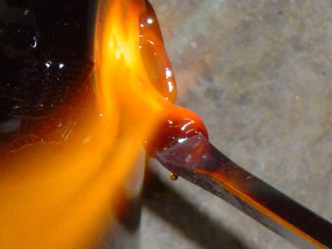 1979 Ford Bronco - Molten glass is being shaped by a tool, with a Supermotors.net logo in the corner.