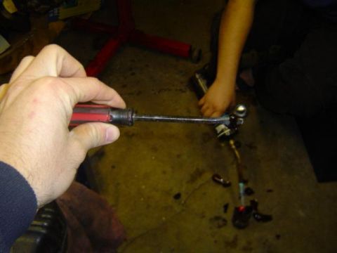 1979 Ford Bronco - A hand uses a screwdriver to work on a car part, with a Supermotors.net logo visible in the corner.