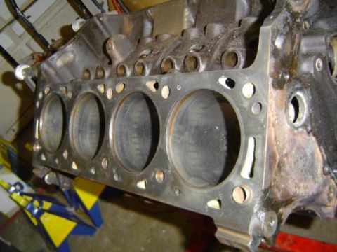 1979 Ford Bronco - Close-up of an engine block, showing the cylinder bores and mounting points.
