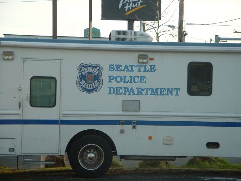 1999 Ford Crown Victoria - Side view of a Seattle Police Department van parked outdoors, with a Pizza Hut sign visible above.