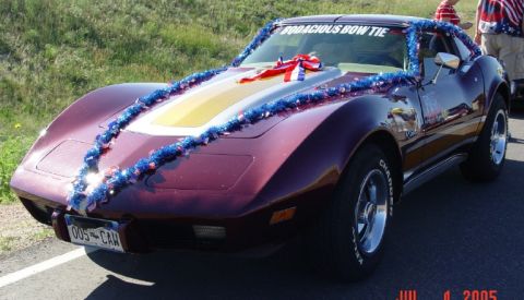1972 Ford Ranchero - This maroon 1975 Chevrolet Corvette is adorned with patriotic tinsel and a bow, ready for a celebration.