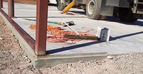 1986 Ford Ranger - A truck is parked at a construction site, surrounded by tools like extension cords and brooms.