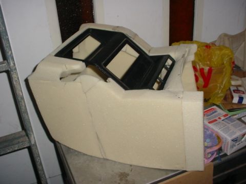 1986 Ford Bronco - A foam mold is being shaped for a vehicle's center console, with cutouts for instrumentation.