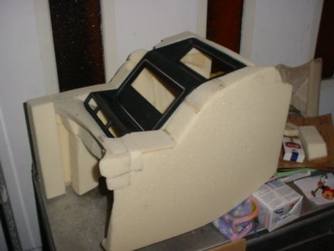 1986 Ford Bronco - A foam mold for a vehicle's center console is shown, with black plastic components visible.