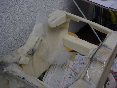1986 Ford Bronco - A project involving foam and fiberglass construction is underway, with some printed material visible beneath the structure.
