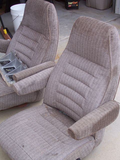 1978 Ford Bronco - Pair of car seats with striped fabric upholstery and armrests, possibly for a truck or SUV.