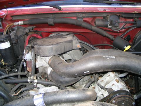 1989 Ford Bronco - Close-up view of the engine bay, showing various hoses and mechanical parts.