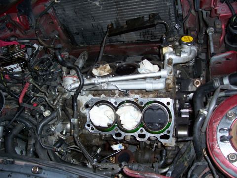 1996 Ford Probe - Engine bay with cylinder head removed, showing pistons and internal components. Red car interior.