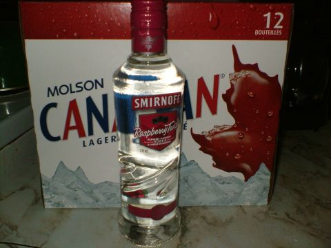 1989 Ford Bronco - A bottle of Smirnoff Raspberry Twist Vodka stands before a box of Molson Canadian Lager.