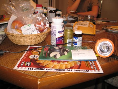 1995 Ford Bronco - A collection of items including food, supplements, and a flashlight are arranged on a wooden table.