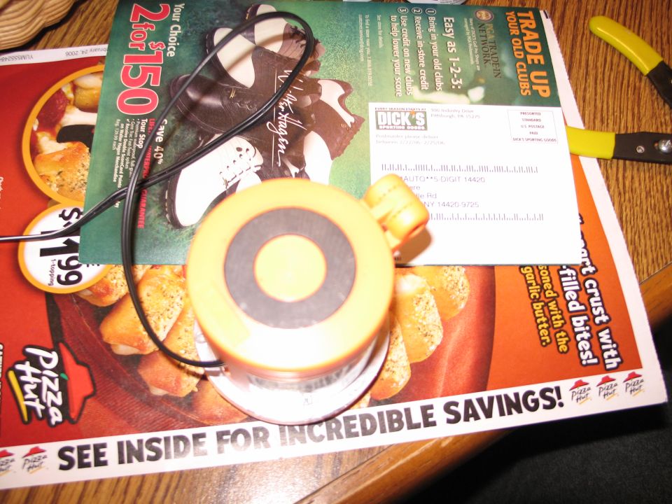 Yellow and black circular object with wire on top of flyers