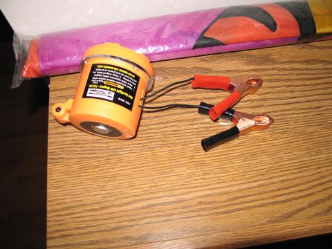 1995 Ford Bronco - A 12V DC spotlight with a magnetic base and alligator clips is shown on a wooden surface.