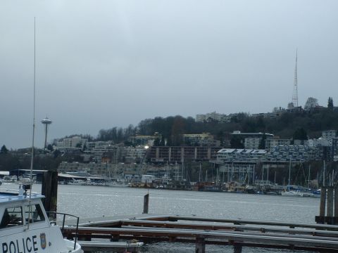 1999 Ford Crown Victoria - A police boat is docked in the foreground with the Seattle skyline visible across the water.