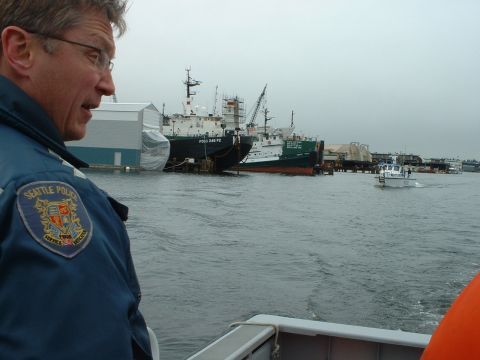 1999 Ford Crown Victoria - A Seattle Police officer observes ships in the harbor from a boat.
