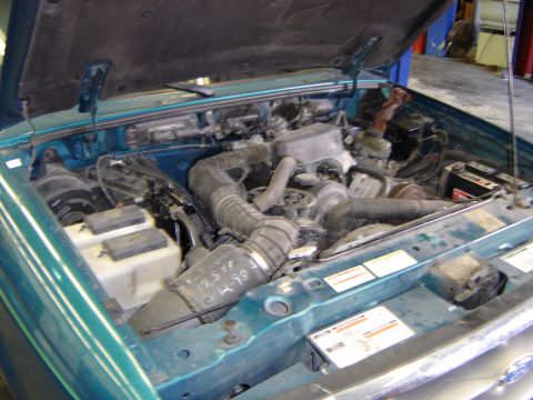 1997 Ford Ranger - Handwritten notes on a hose in the engine bay of a Ford Ranger indicate a date of 12-5-98.