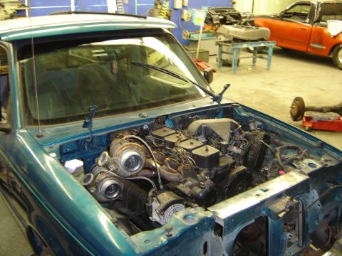 1997 Ford Ranger - Custom diesel engine swap in a teal pickup truck, with another vehicle visible in the background.