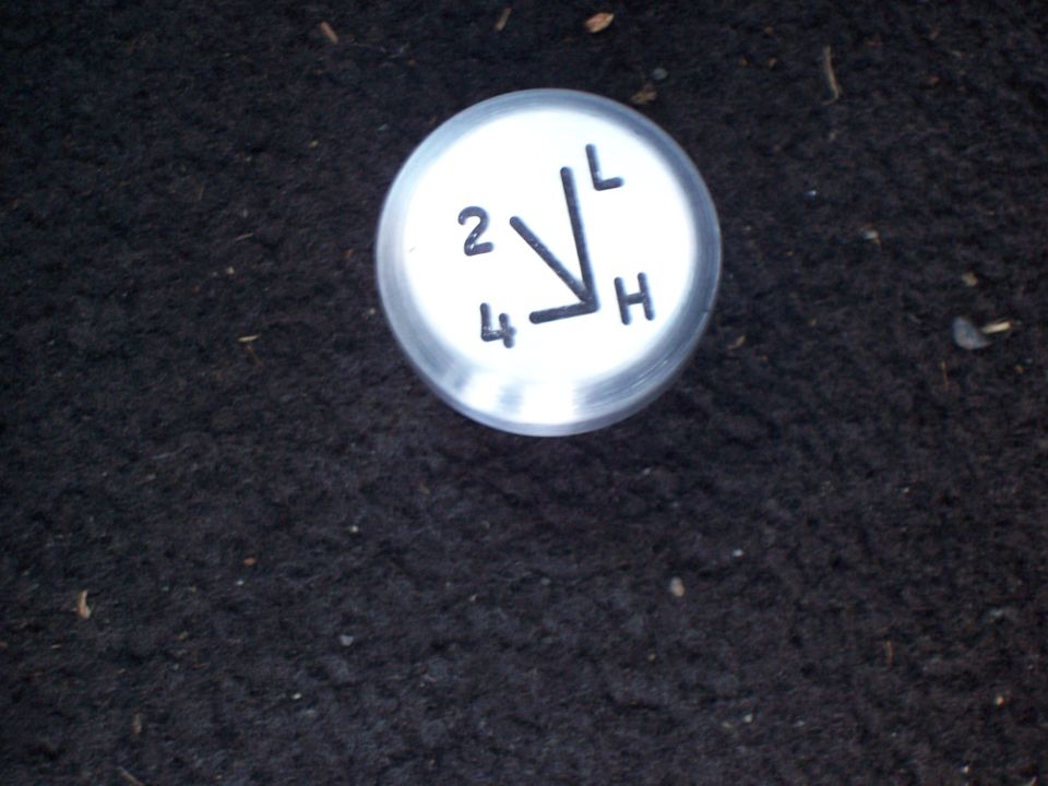 Aluminum transfer-case shift knob engraved 2-4-L-H pattern on carpet