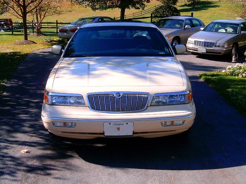 Front view of gold Mercury Grand Marquis with waterfall grille and Maryland plate