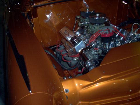 1970 Ford Ranchero - Close-up of a custom engine bay with polished chrome components and vibrant orange paint.